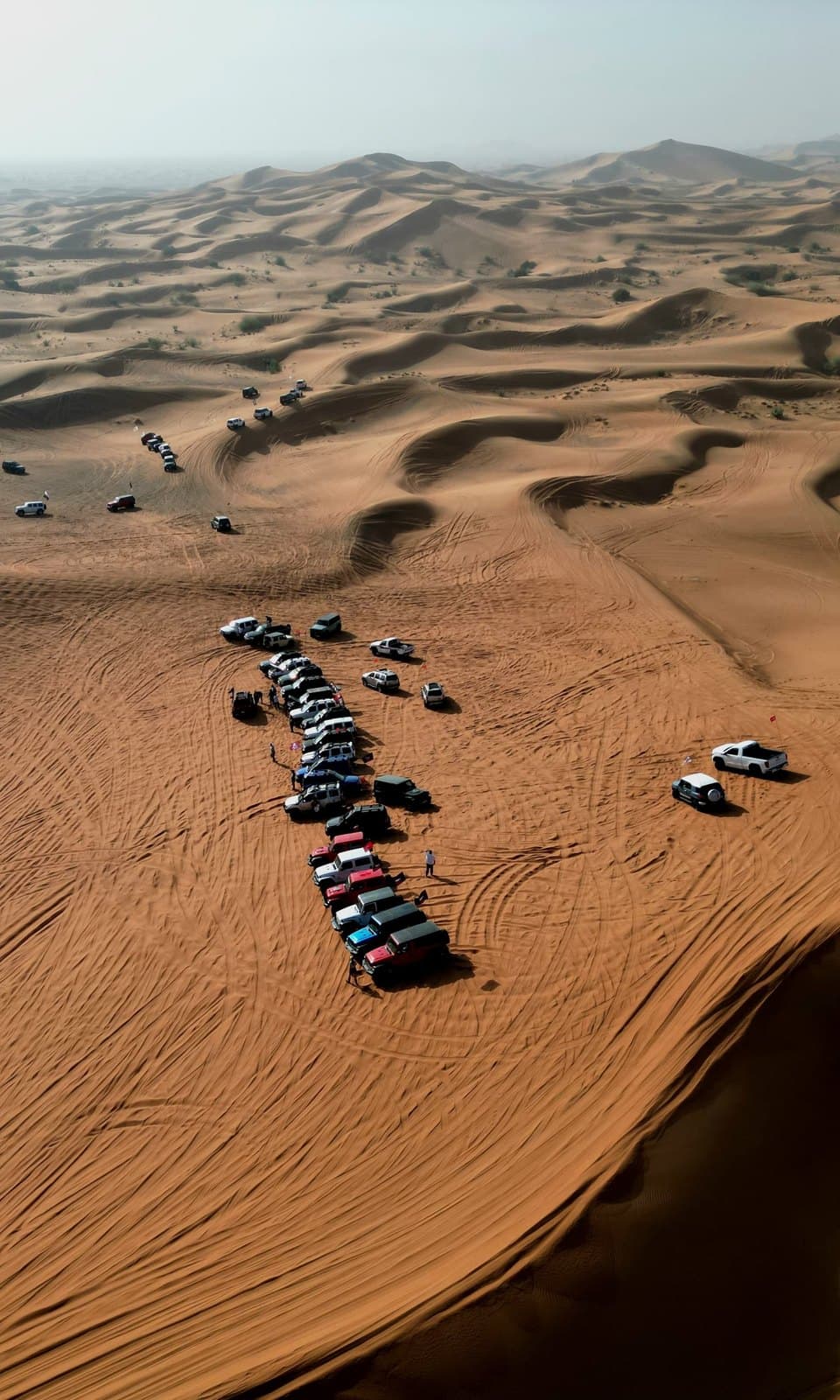 Aerial view of a Jeep convoy crossing the dunes