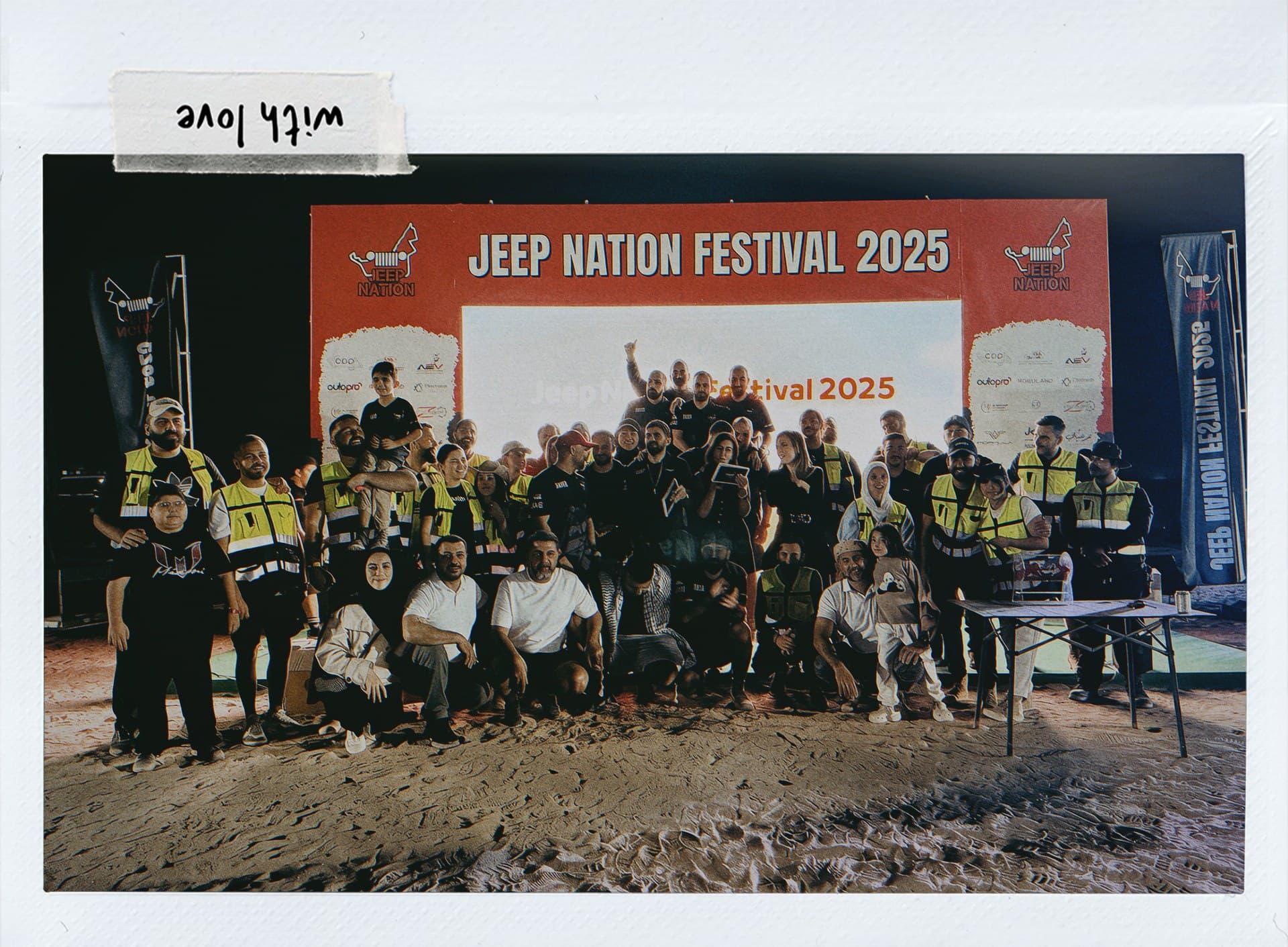 A print of the 2025 Jeep Nation Festival group photo, taped to the page