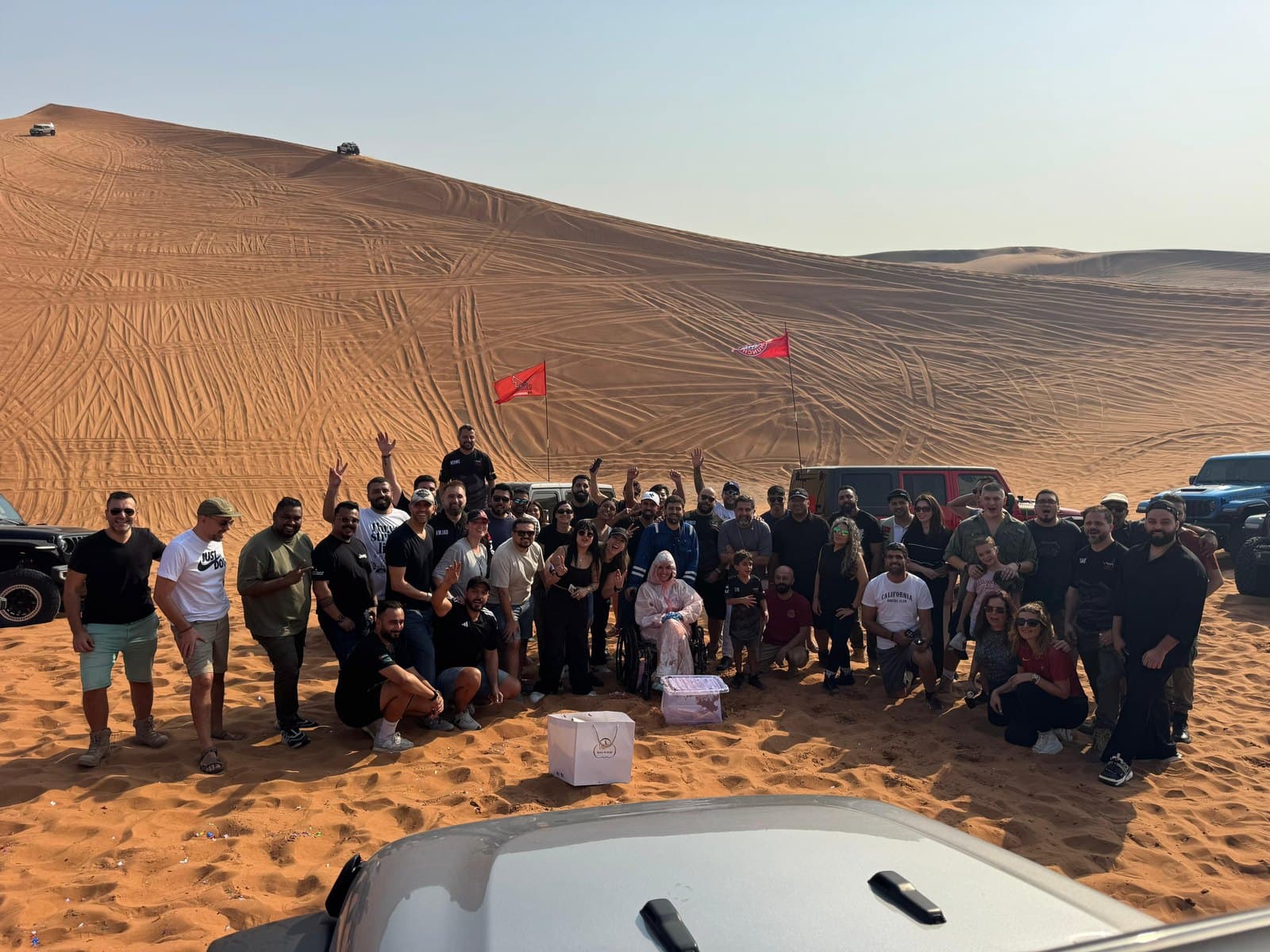 The club gathered for a group photo on a dune