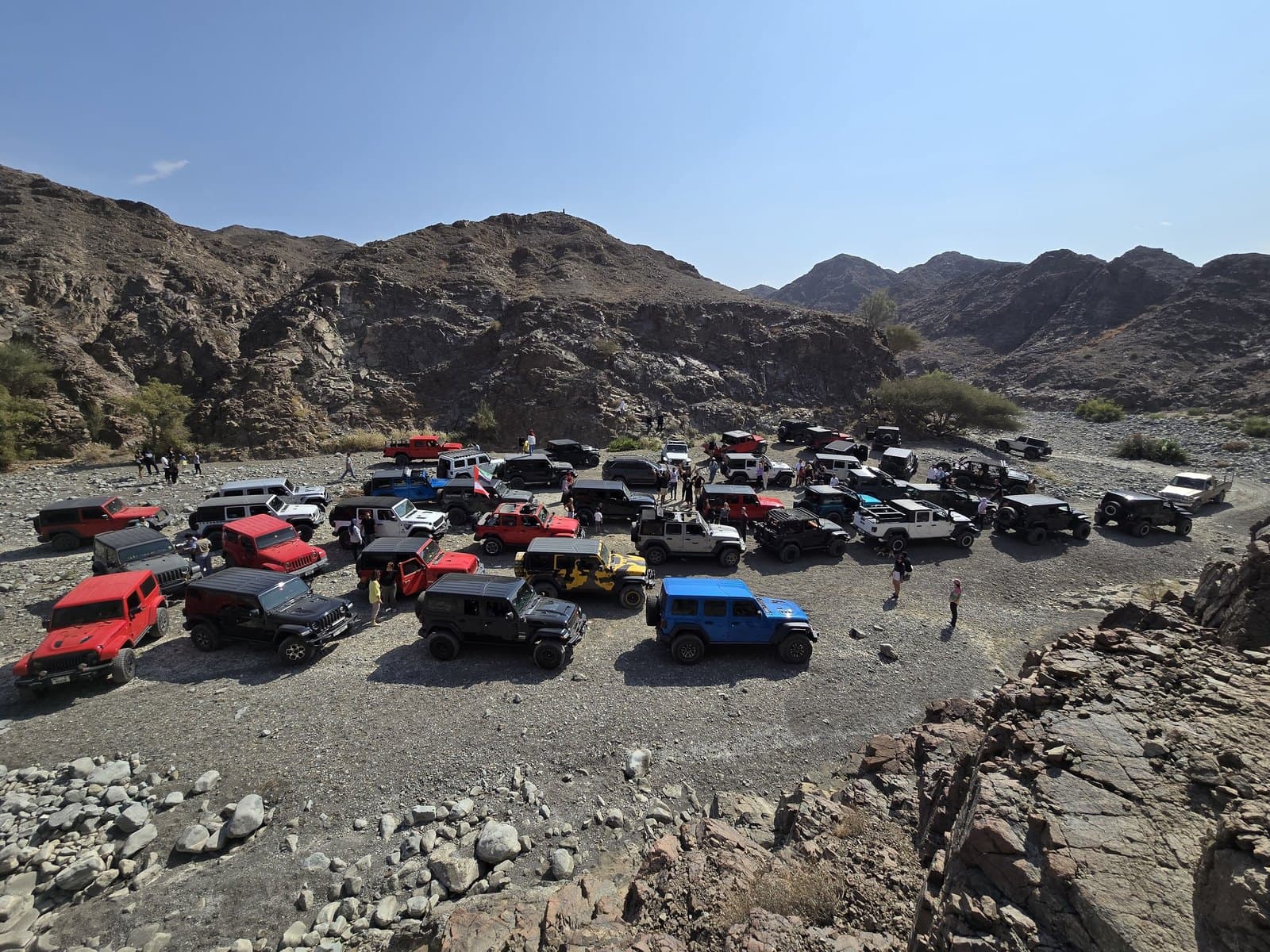 Dozens of Jeeps gathered in a rocky mountain valley