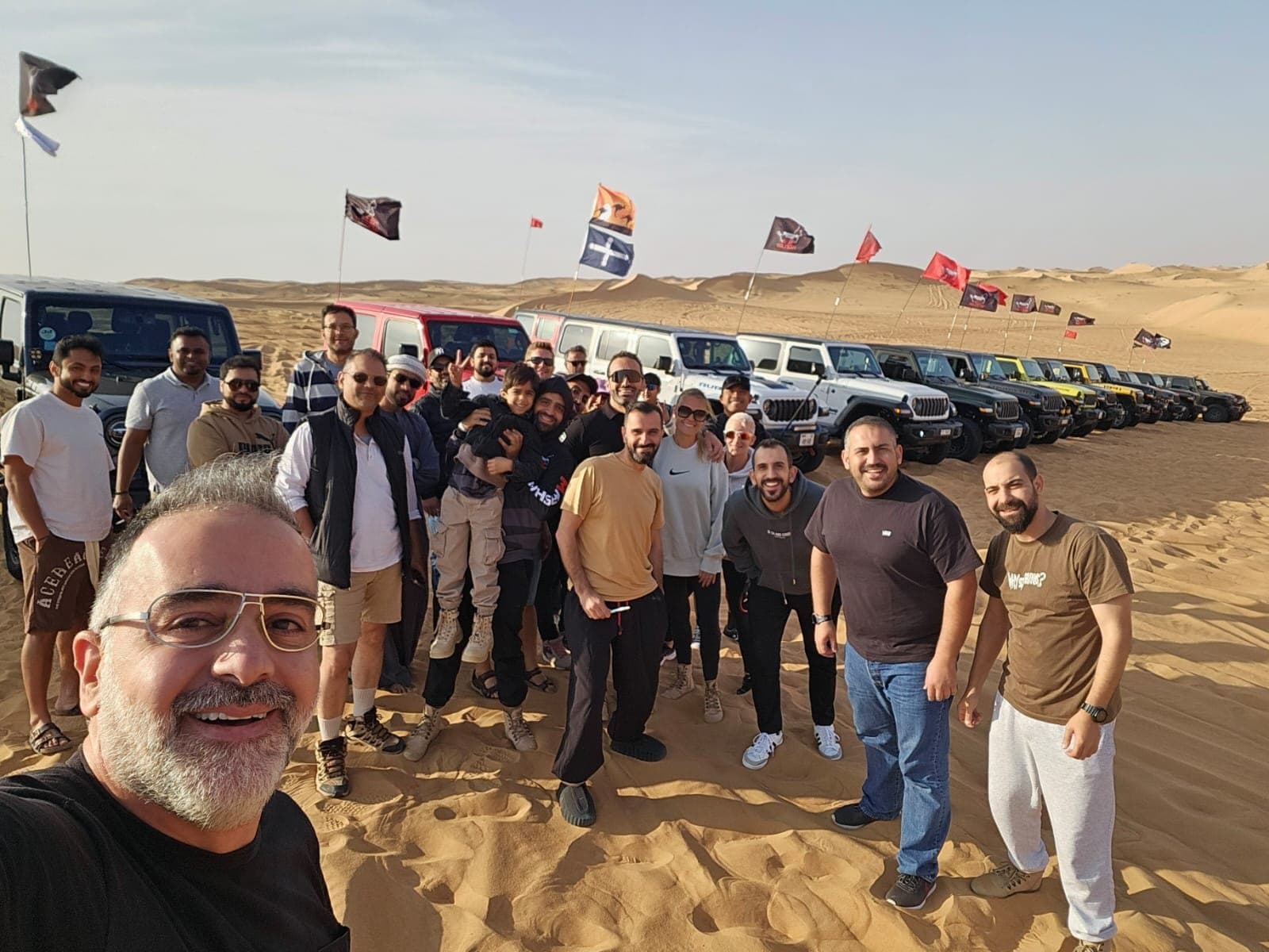 Members gathered for a photo in front of the convoy